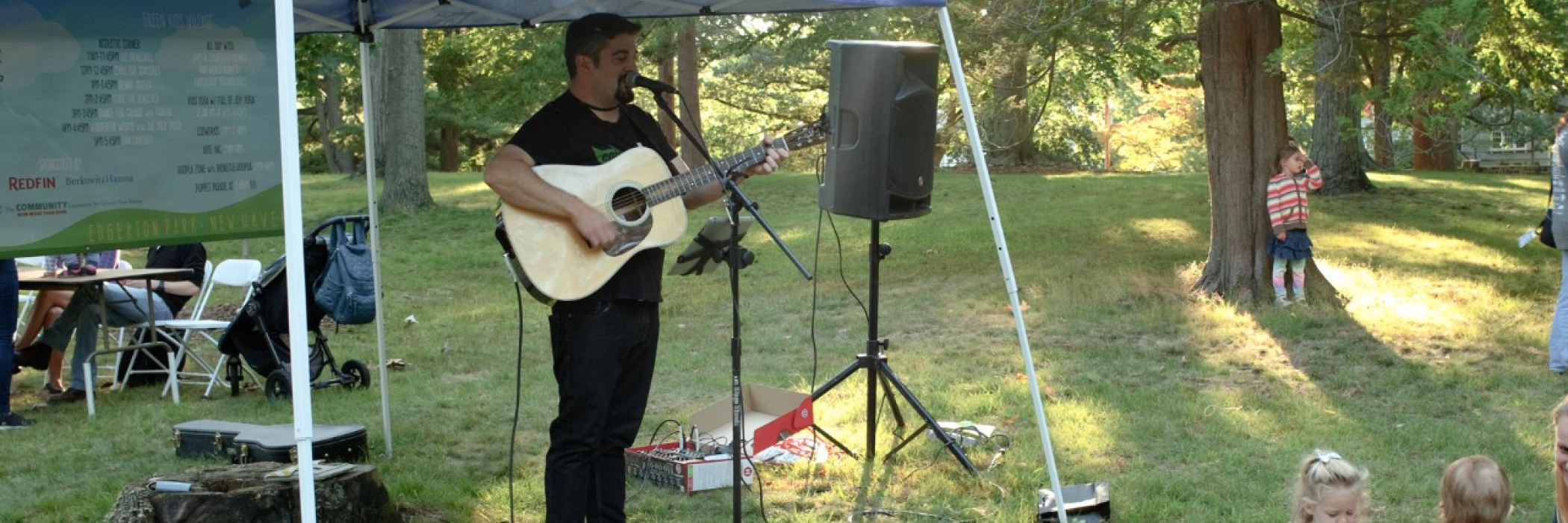 Dan Carlucci playing the guitar in the park