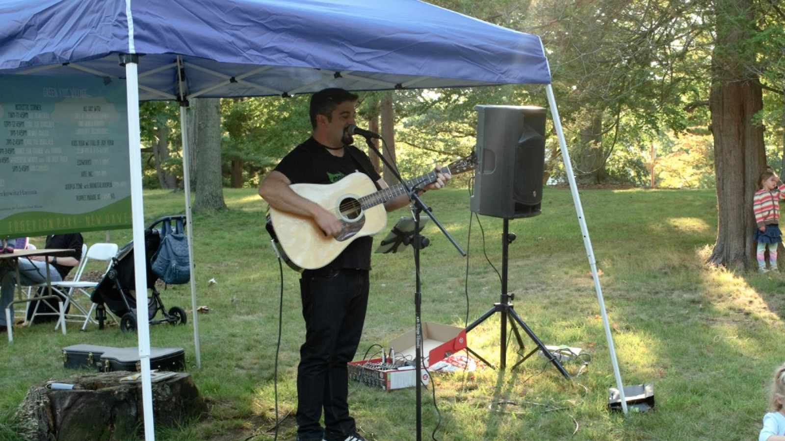 Dan Carlucci playing the guitar in the park