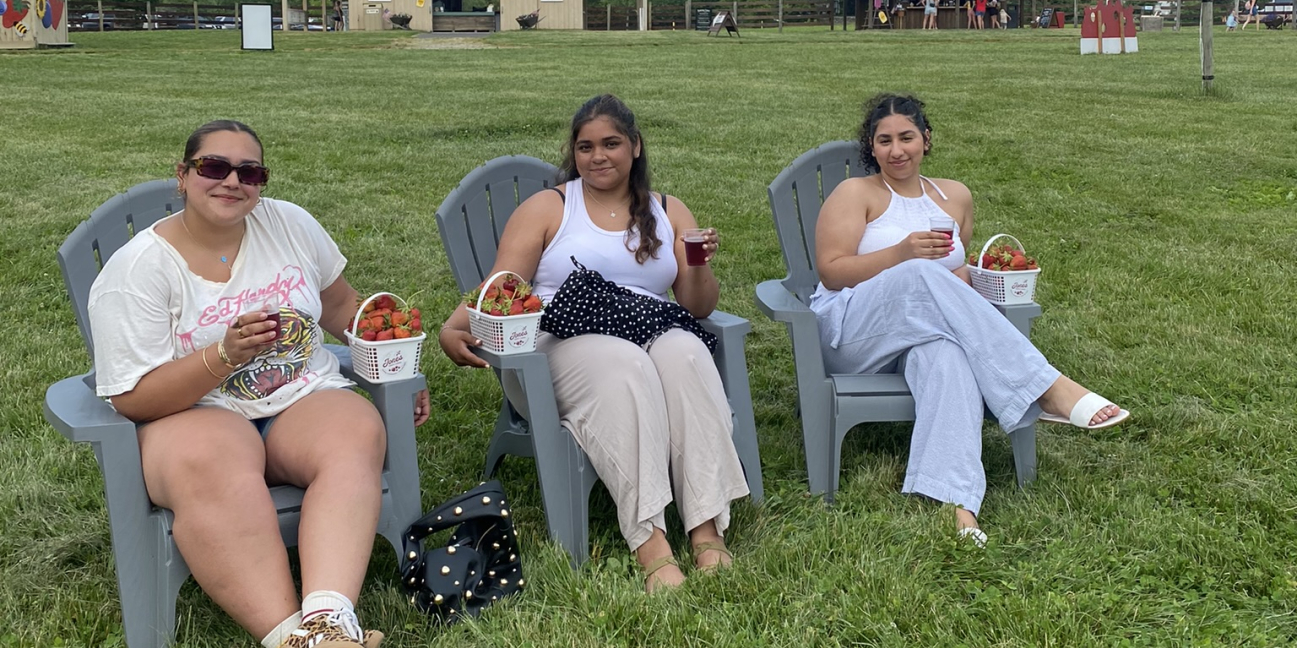Group enjoying wine after picking strawberries 