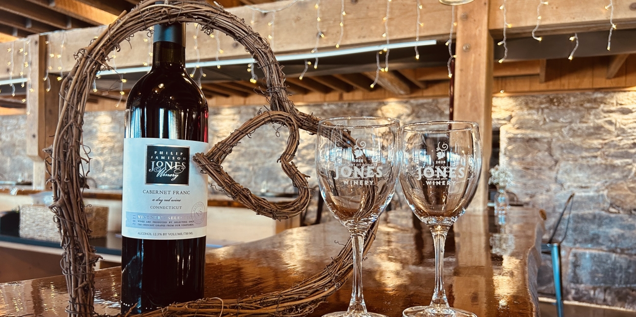 Winery Valentine's Day with wine glasses alongside a heart wreath