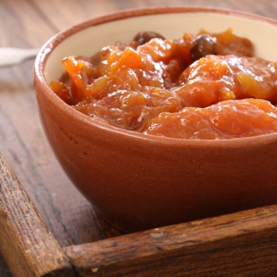 a bowl on a serving tray of Squash and Apricot Chutney